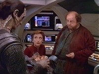 Razka Karn überreicht Dukat und Kira ein Trümmerstück.